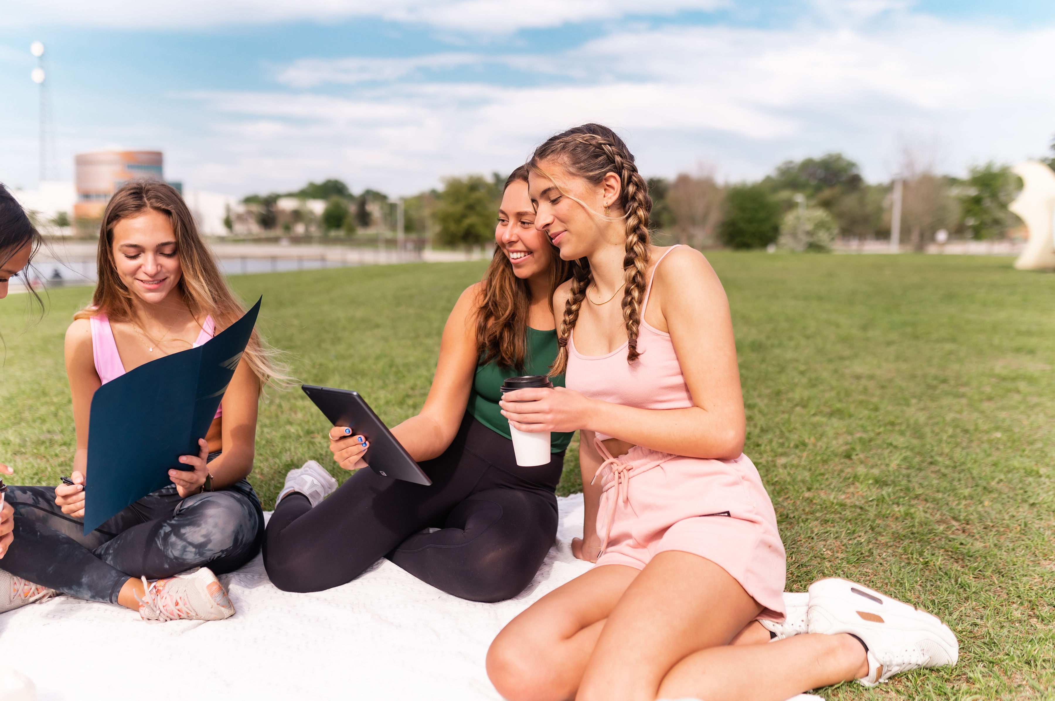 Four girls study on the lawn at Depot Park near UF