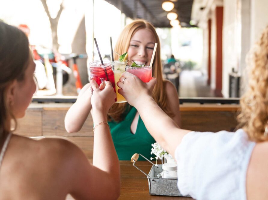 three UF girls cheers drinks at the oak restaurant in gainesville florida