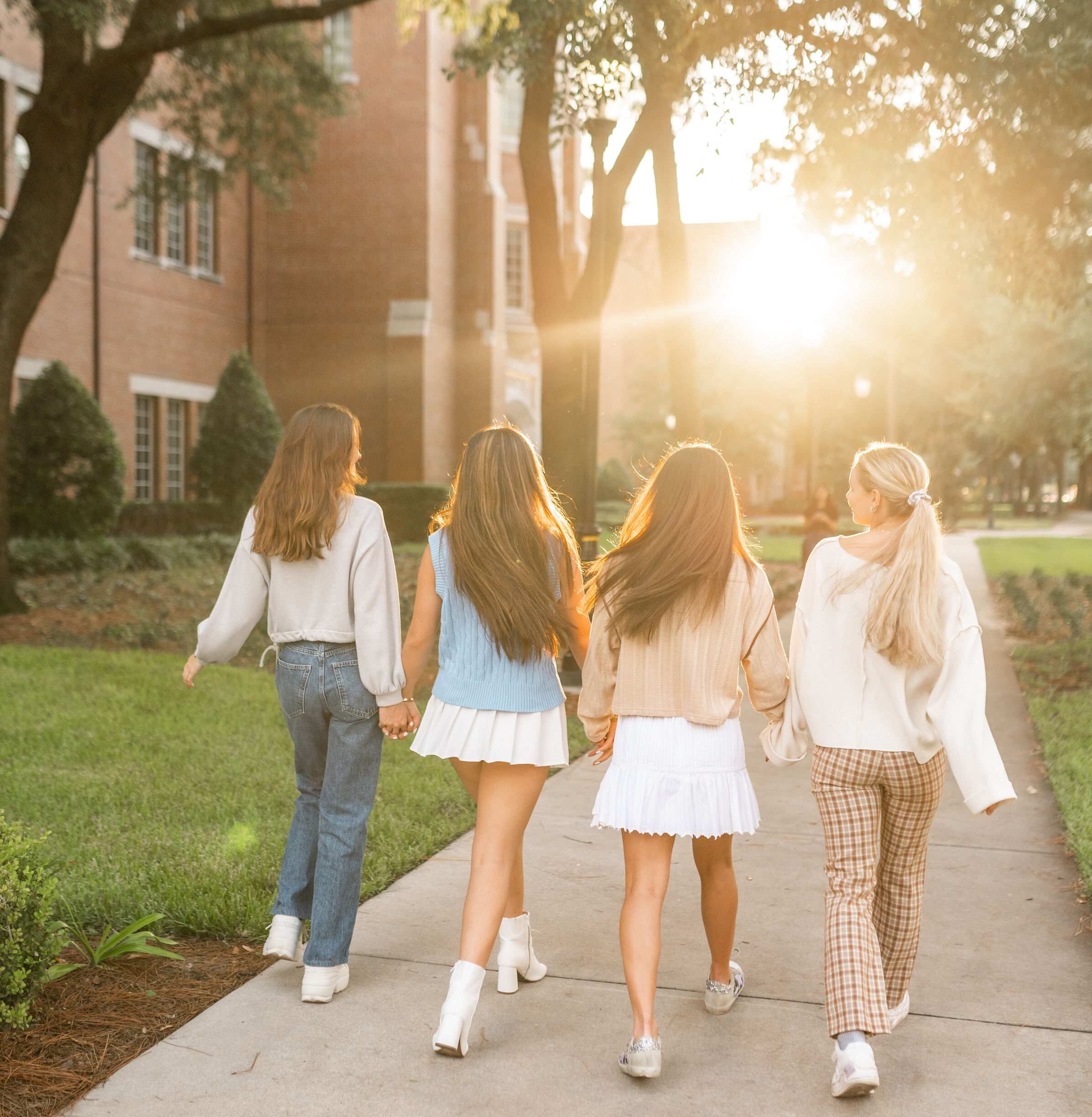 four girls walk through campus at the university of florida